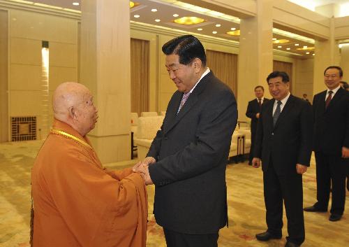 Jia Qinglin (front R), chairman of the National Committee of the Chinese People's Political Consultative Conference(CPPCC), shakes hands with Chuan Yin, the newly elected president of the Buddhist Association of China, in Beijing, capital of China, Feb. 3, 2010. Jia met with the delegates of the eighth national conference of the Buddhist Association of China in Beijing on Wednesday. 