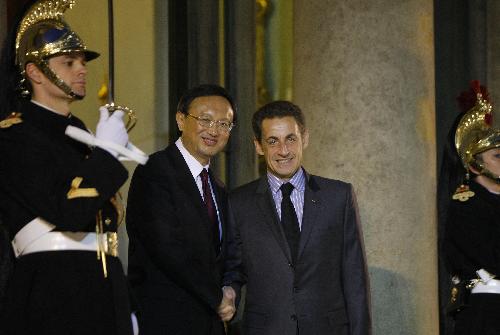 French President Nicolas Sarkozy (R) shakes hands with visiting Chinese Foreign Minister Yang Jiechi in Paris, France, Feb. 4, 2010. [Zhang Yuwei/Xinhua]