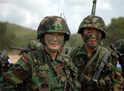 A female soldier (L) from the Republic of Korea poses with her comrade in arms during a landing drill of the Cobra Gold multinational military exercise in Sattahipp of Changwat Chon Bury, Thailand, Feb. 4, 2010.[Shi Xianzhen/Xinhua] 