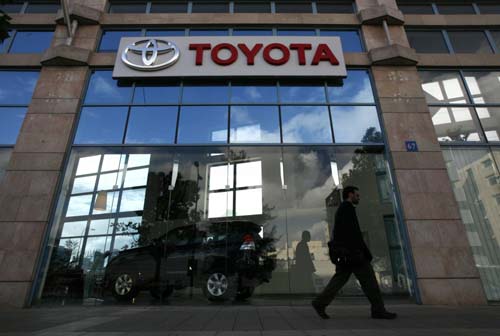 An Israeli man walks past a Toyota dealership in Tel Aviv February 3, 2010. Faced with an unprecedented recall of millions of vehicles and rivals swooping in on its customers, the public relations machine at Toyota Motor Corp -- one of the most savvy brand-creators in Asia -- is floundering.