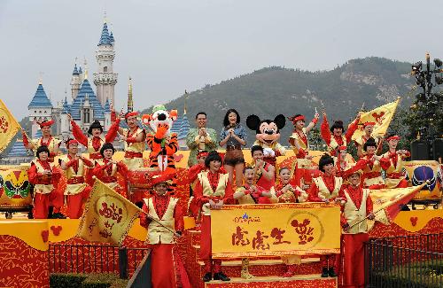 Actors pose for family photos during a performance to celebrate the upcoming Spring Festival at Disneyland in south China's Hong Kong Feb. 4, 2010. This Spring Festival, the Chinese New Year by the lunar calendar, falls on Feb. 14. 2010. 
