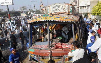 People around the scene of a blast in the Pakistani port city of Karachi on Februray 5, 2010.