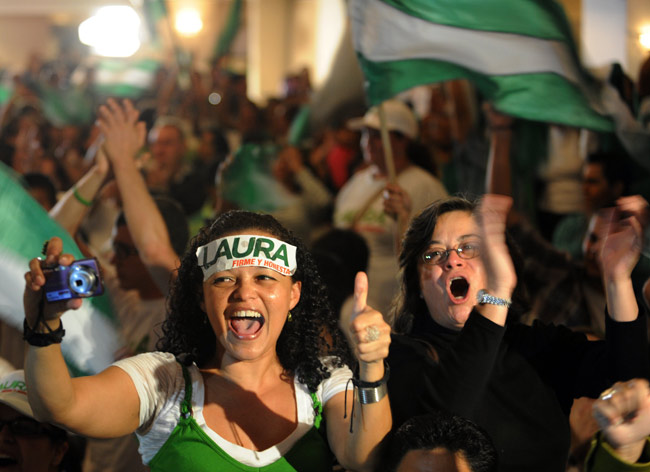 Supporters of ruling party candidate Laura Chinchilla celebrate in San Jose, Costa Rica, Feb. 7, 2010. Ruling party candidate Laura Chinchilla declared victory Sunday night in Costa Rica&apos;s Feb. 7 presidential election, after her main rivals, Otton Solis and Otto Guevara, had conceded defeat and congratulated her as the country&apos;s first female president in history. [Xinhua/Esteban Dato]