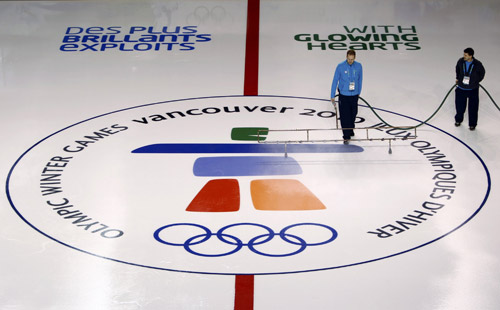  Technicians water the ice surface at the UBC Thunderbird Arena, the venue for ice hockey events, in preparation for the Vancouver 2010 Winter Olympics February 5, 2010. The Games start February 12. [Xinhua/Reuter]