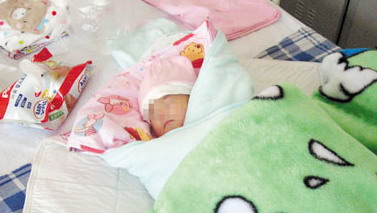 The newborn girl suffers from a congenital defect that blocks the anus, and other problems.
