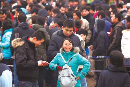 A woman is all smiles after she snagged tickets at Beijing Railway Station yesterday.