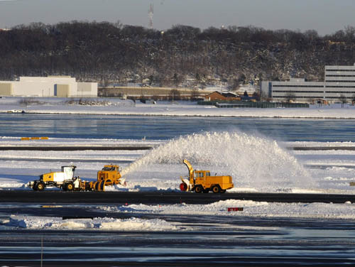 Snow removing equipment are busy at work clearing the runways after a heavy snowstorm at Washington Reagan National Airport in Washington, D.C.,the United States. [Xinhua]