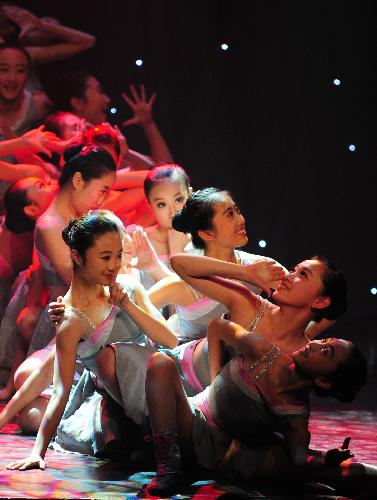 Dancers from the Art Troupe of the High School Affiliated to Renmin University (RDFZ) of China perform dance 'Flying Phoenix' in Wellington College, Crowthorne of Berkshire, Britain, Feb. 8, 2010.