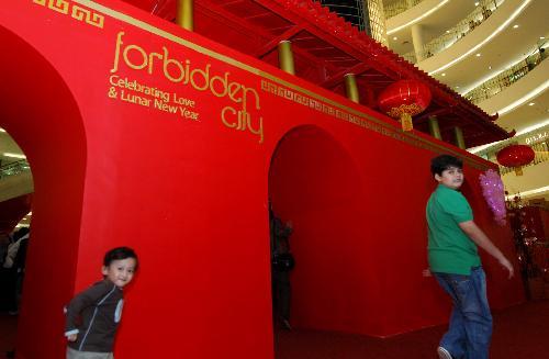 Children play around a model of the Forbidden City at Senayan City, a shopping mall in Jakarta, capital of Indonesia, Feb. 8, 2010. Festive decorations are seen in shopping centers in Jakarta as Lunar New Year of the Tiger, that falls on February 14, 2010. [Xinhua photo]