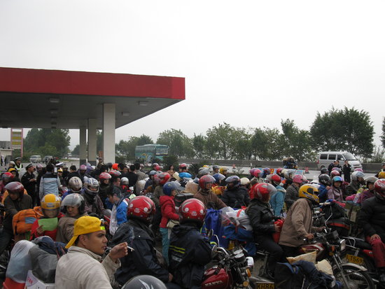 The photo taken on Monday, February 8, 2010, shows that migrant workers in Pearl River Delta Economic Zone of south China's Guangdong province are on their way home by motorcycle for Chinese New Year. [CFP]