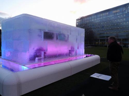 A giant tattoo ice cube is displayed at Potters Fields, close to the Tower Bridge, in London, Feb. 9, 2010. The ice cube was made by London&apos;s famous tattoo artist Henry, who used Japanese Samurai chisels to carve the unique tattoo design into it. A stylish car called &apos;Cube&apos; is frozen at the centre of the ice cube and will be shown to the public as the ice melts in the following three days. [Xinhua] 