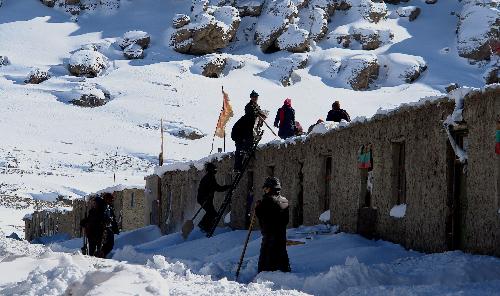 Local residents clear snow in Burang of Ngari Prefecture in southwest China's Tibet Autonomous Region, Feb. 10, 2010. Blizzard also hit parts of southwest China's Tibet Autonomous Region since Monday. As of Tuesday night, the Ngari Prefecture had reported 21.7 mm of precipitation and the fresh snow on the ground measured 23 centimeters. 