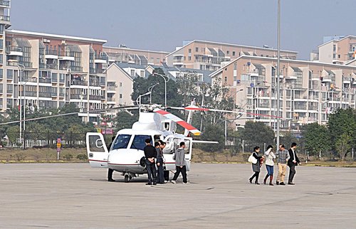 Friends and Relatives walk out of the helicopter after being invited to share the flight over the city of Fuzhou in Fujian province on February 9, 2010.