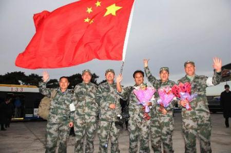 Members of the Chinese medical team pose for a group photo at Beijing Capital International Airport in Beijing, capital of China, Feb. 10, 2010.