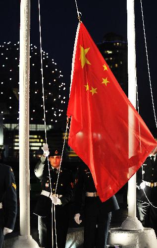 Honor guards raise China's national flag during the flag-raising ceremony to the Vancouver 2010 Winter Olympic Games in Vancouver, Feb. 10, 2010.