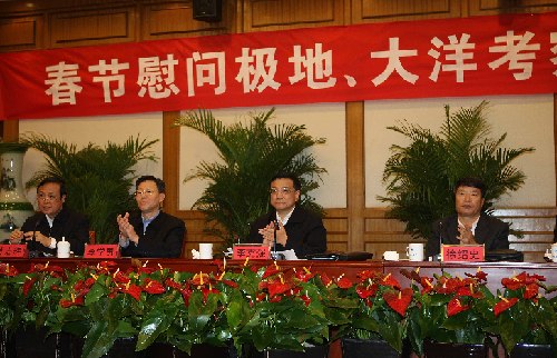 Chinese Vice Premier Li Keqiang (2nd R) salutes to members of Chinese exploration teams at the Antarctica, the Arctic and on the ocean through video telephone at the State Oceanic Administration in Beijing, China, Feb. 11, 2010.