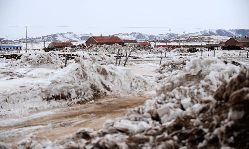 Snow is seen near a village in Xilingol League of north China's Inner Mongolia Autonomous Region, Feb. 11, 2010. With the help from central and local governments, which had spent more than 136 million yuan (some 20 million US dollars) to relieve the snow disaster in Inner Mongolia until January, more than 2 million people affected by the disaster try their best to overcome the difficulties and prepare for the Spring Festival which falls on Feb. 14. 