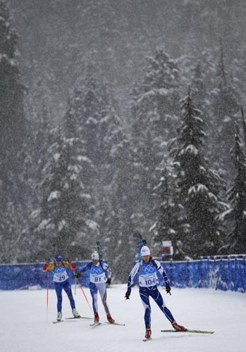 Competitors ski the through heavy snowfall during a training session for the women's biathlon event at the Vancouver 2010 Winter Olympics in whistler, British Columbia, February 11, 2010. A headache of organisers is the weather in the region, on Canada's west coast, which has been unseasonably warm in recent weeks,and the lack of snow have hampered preparations. 