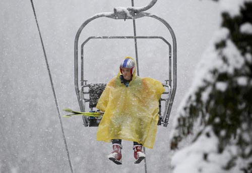 Austria's Gregor Schlierenzauer sits in a chairlift on his way to a training session for the men's ski jumping event at the Vancouver 2010 Winter Olympics in Whistler, British Columbia, February 11, 2010. A headache of organisers is the weather in the region, on Canada's west coast, which has been unseasonably warm in recent weeks,and the lack of snow have hampered preparations.