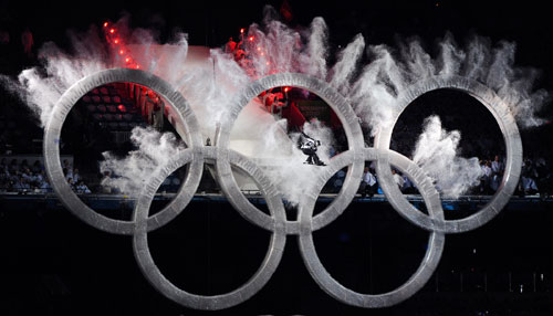 A snowboard athlete jumps over the Olympic rings on the opening ceremony for the 2010 Winter Olympic Games inside the BC Place stadium in Vancouver, Canada on Feb. 12, 2010. [Qi Heng/Xinhua]