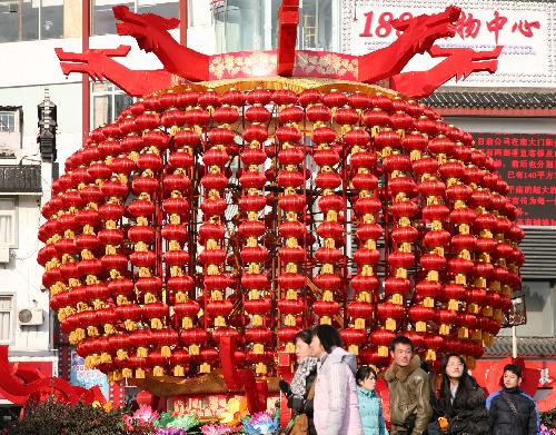 People walk past a huge set of lanterns in Nanjing, capital of east China's Jiangsu Province, Feb. 12, 2010. [Wang Xin/Xinhua]