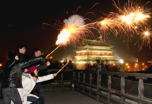 Foreign college students set off fireworks in Beijing, capital of China, Feb. 13, 2010, in celebration for the Spring Festival, the Chinese traditional lunar New Year starting from Feb. 14 this year. (Xinhua Photo)