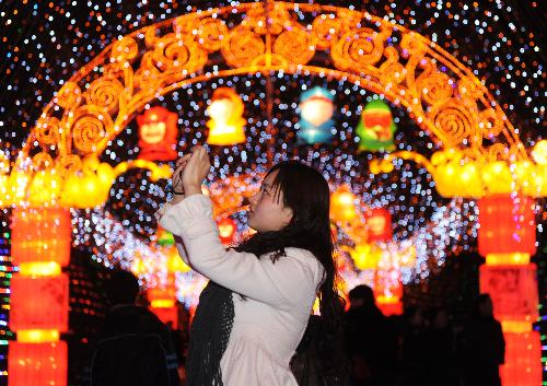 A visitor shoots colorful lanterns at a temple fair in Chengdu, capital of southwest China's Sichuan Province, Feb. 11, 2010. The temple fair kicked off Thursday and will last till March 3 for the Spring Festival celebrations. (Xinhua/Jiang Hongjing)