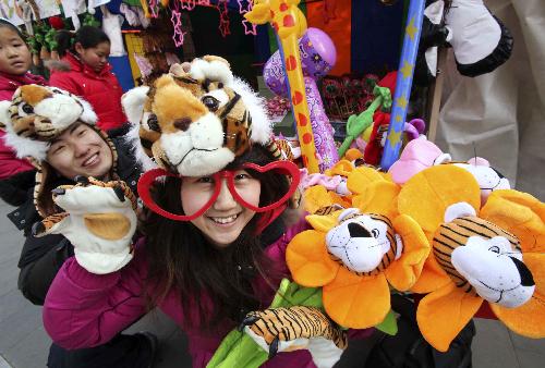 Young people show their 'tiger' caps at the Ditan temple fair in Beijing, capital of China, Feb. 13, 2010. 