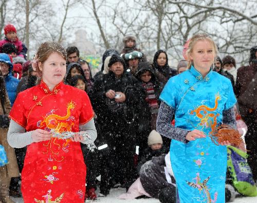 Two Swedish students display traditional Chinese costume qipao during a celebration for the Chinese Spring Festival, or lunar New Year, in Stockholm, capital of Sweden, on Feb. 13, 2010. (Xinhua/He Miao) 