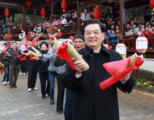 Chinese President Hu Jintao dances with residents at Wulong Village in Gutian Town of Shanghang County under Longyan City, southeast China's Fujian Province, February 13, 2010.