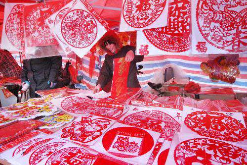 Photo taken on February 12, 2010 shows a booth selling paper-cutting products for window decoration on a street in Ganyu County, east China's Jiangsu Province.