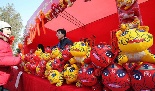 People stroll around the Ditan Park Temple Fair on February 13, 2010, the Chinese lunar New Year's eve. Ditan Park, or Temple of Earth, annually holds Beijing's most popular temple fair, usually featured with the traditional food and folk art works.