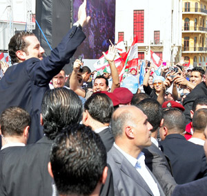 Lebanon&apos;s Prime Minister Saad Hariri (L), son of Rafic Hariri, waves to the crowd in Beirut, Lebanon, Feb. 14, 2010. (Xinhua Photo)