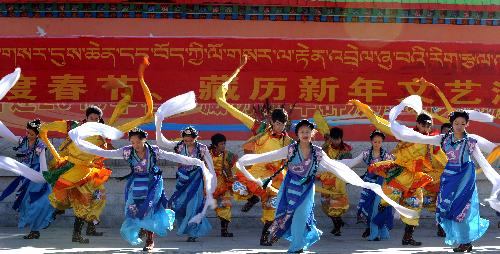 Dancers perform at the Longwangtan Park for the lunar New Year of the Tiger according to the Tibetan calendar, in Lhasa, capital of southwest China's Tibet Autonomous Region, Feb. 14, 2010.