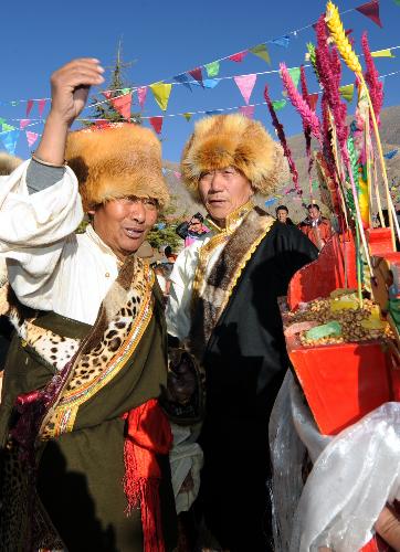 People of the Tibetan ethnic group attend a celebration for the lunar New Year of the Tiger according to the Tibetan calendar, in west Lhasa, capital of southwest China's Tibet Autonomous Region, Feb. 14, 2010. 