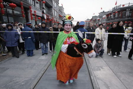 A folk artist waits to perform on Qianmen Street in Beijing on the first day of the Chinese New Year.[