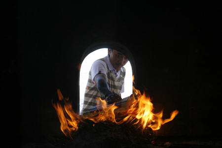 Lim Kain Chee, an ethnic Chinese, burns prayer papers during Chinese New Year at a temple in Sepang outside Kuala Lumpur February 14, 2010.