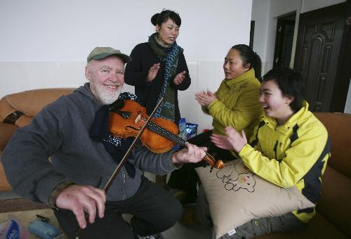 David from the U.S. plays violin during a Spring Festival family party in Rongshui Miao Autonomous County, southwest China's Guangxi Zhuang Autonomous Region, Feb. 13, 2010. David spent the eve of the Chinese Spring Festival, or lunar New Year, at his Chinese father-in-law's home in Rongshui, enjoying the Chinese traditional family reunion pleasure. 