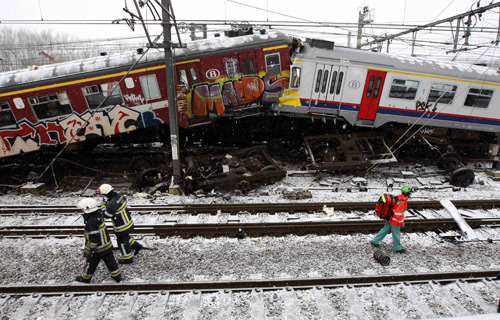 Emergency crew work on the site where two trains crashed near Halle February 15, 2010. Two trains crashed head-on outside Brussels on Monday, killing at least 20 people, officials and Belgian broadcaster VRT said.