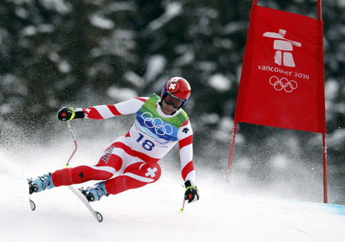 Switzerland's Didier Defago clears a gate during the men's alpine skiing downhill event at the Vancouver 2010 Winter Olympics in Whistler, British Columbia February 15, 2010.