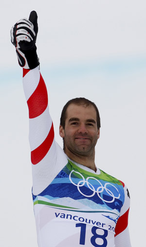 Switzerland's gold medalist Didier Defago gives a thumb up during the victory ceremony for the men's Alpine Skiing Downhill race of the Vancouver 2010 Winter Olympics in Whistler, British Columbia, February 15, 2010.