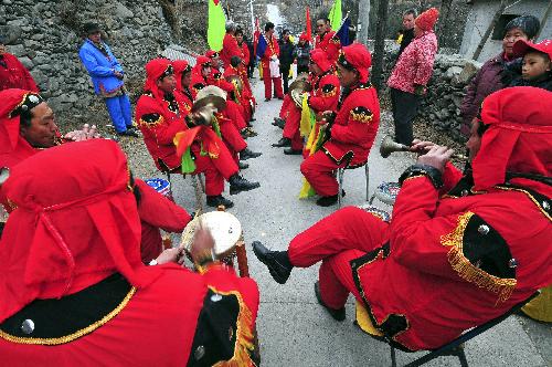 Folk artists play traditional Chinese instrumental music at Beijiao village in suburbs of Beijing, capital of China, Feb. 14, 2010.