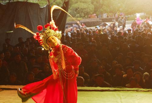 A Shaoxing Opera enthusiast performs for local residents to celebrate the spring festival at a park in Wenling city, east China's Zhejiang Province, Feb. 15, 2010.