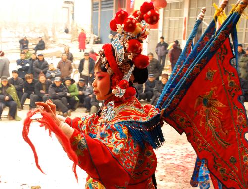 An actress performs Henan Opera for villagers to celebrate the spring festival at Dongzhuzhuang Village in Zaozhuang, east China's Shandong Province, Feb. 15, 2010.