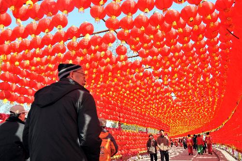 People walk under the red lanterns at a temple fair in Taiyuan, north China's Shanxi Province, Feb. 15, 2010.