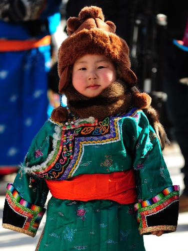 A boy poses during a show of Mongolian winter dresses in Dong Ujimqin Banner, Xilin Gol League, north China's Inner Mongolia Autonomous Region, on Feb. 16, 2010. Twenty teams from various parts of Inner Mongolia took part in the show on Tuesday. 