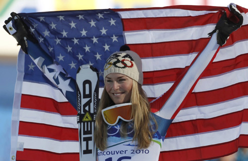 Gold medalist Lindsey Vonn of the U.S. holds up her country's flag as she celebrates winning the women's Alpine Skiing Downhill race at the Vancouver 2010 Winter Olympics in Whistler, British Columbia, February 17, 2010.