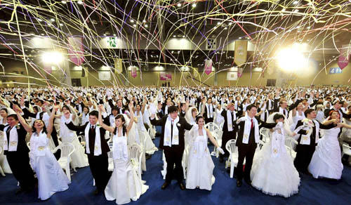 Newlyweds celebrate after their mass wedding ceremony organized by the Unification Church in Goyang, near Seoul, February 17, 2010. Some 10,000 couples from about 20 countries around the world exchanged wedding vows on Wednesday, the church said. The Unification Church founded by South Korean evangelist Reverend Moon Sun-myung in Seoul in 1954, performed its first mass wedding in 1961 with 33 couples.