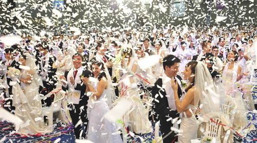 Newlyweds celebrate after their mass wedding ceremony organized by the Unification Church in Goyang, near Seoul, February 17, 2010.