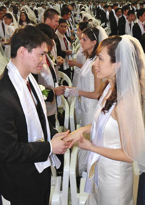 Newlyweds take part in a mass wedding ceremony organized by the Unification Church in Goyang, near Seoul, February 17, 2010.